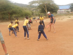 Harry teaching catching skills to the children