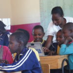 Teacher agness teaching the pupils with the chrome books